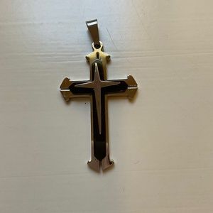 Silver/black cross, 2 3/4 by 1 1/2”, aluminum, never worn.